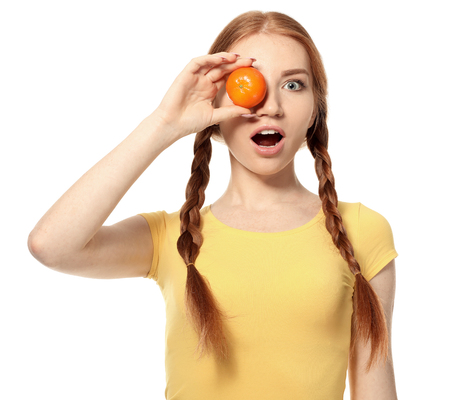 Emotional young woman with citrus fruit on white backgroundの写真素材