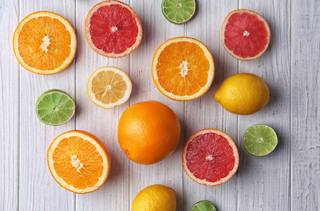 Composition with fresh citrus fruits on wooden table