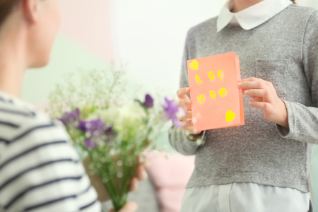 Little girl greeting her mother at homeの写真素材