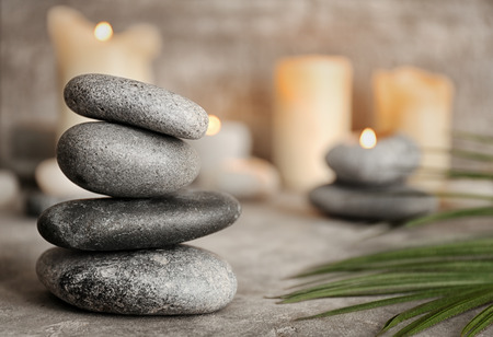 Stack of spa stones on grey tableの写真素材