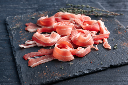 Rashers of bacon on slate plateの写真素材