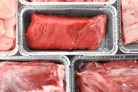 Raw meat in foil containers, closeupの写真素材