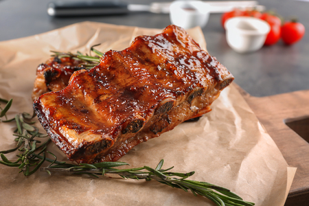 Delicious grilled ribs with rosemary on parchment, closeupの写真素材