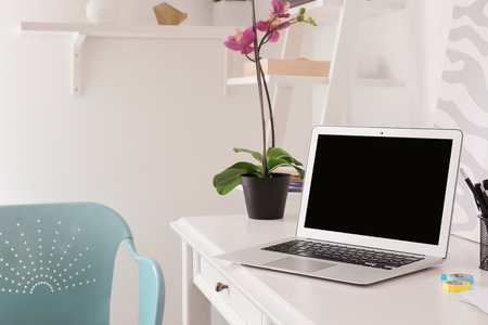 Stylish modern workplace with laptop at homeの写真素材