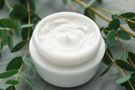 Jar of cream with herbal extract on grey background, closeupの写真素材