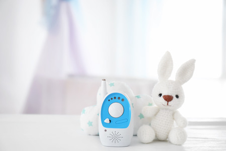 Baby monitor and toys on table in room. Radio nannyの写真素材