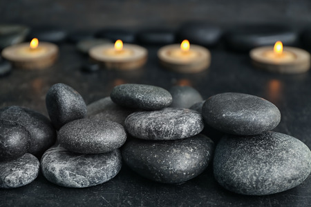 Pile of spa stones on dark tableの写真素材