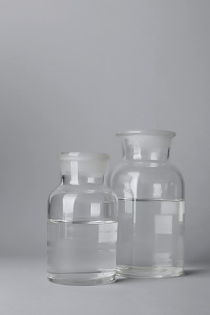 Glass bottles with water on light backgroundの写真素材