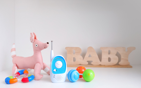 Baby monitor and toys on shelfの写真素材