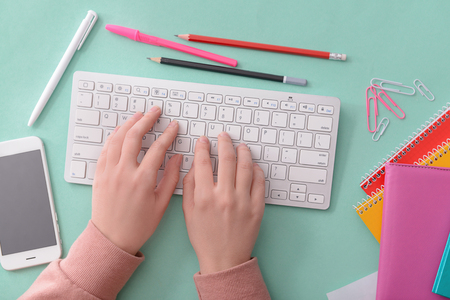 Young woman working with computer at table, top view. Modern workplaceの写真素材