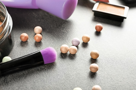 Face powder balls and brush on grey tableの写真素材