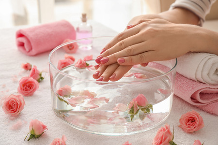 Young woman undergoing spa manicure treatment in beauty salonの写真素材
