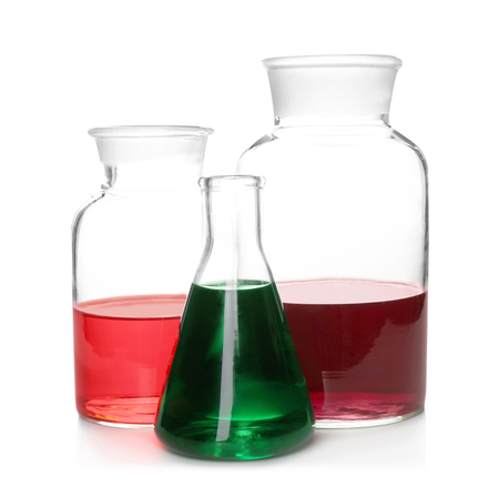 Chemical glassware with colorful samples on white backgroundの写真素材