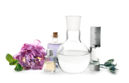 Composition with bottles of essential oils, ingredients and laboratory glassware on white background. Natural cosmeticsの写真素材