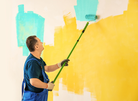 Male painter in uniform working indoorsの写真素材