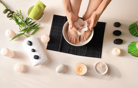 Young woman undergoing spa pedicure treatment in beauty salonの写真素材