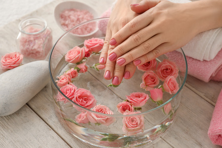 Young woman undergoing spa manicure treatment in beauty salonの写真素材