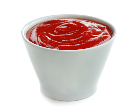 Tasty tomato sauce in bowl on white backgroundの写真素材