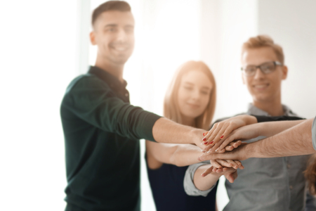 Group of business people putting hands together in officeの写真素材
