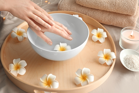 Young woman undergoing spa manicure treatment in beauty salonの写真素材