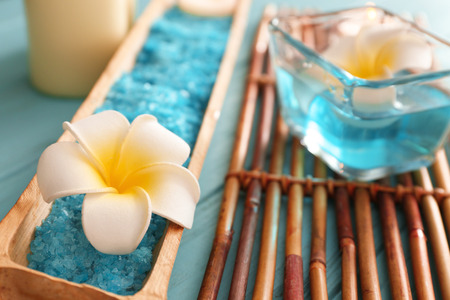 Bamboo tray with flower and sea salt for spa treatment on tableの写真素材