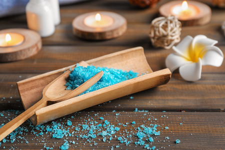 Scoop with sea salt for spa procedures on wooden tableの写真素材