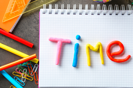 Word TIME made of color plasticine on notebookの写真素材