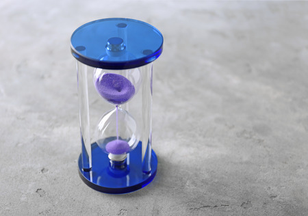 Stylish hourglass on table. Time management concept