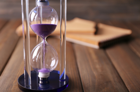 Stylish hourglass on table. Time management concept
