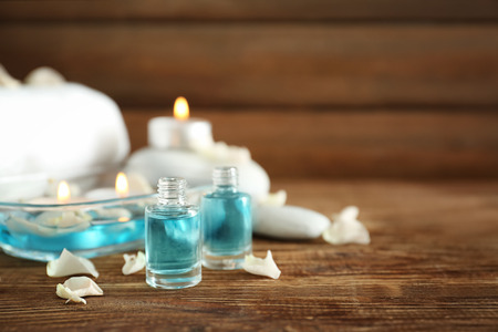 Bottles of essential oil for spa procedures on tableの写真素材