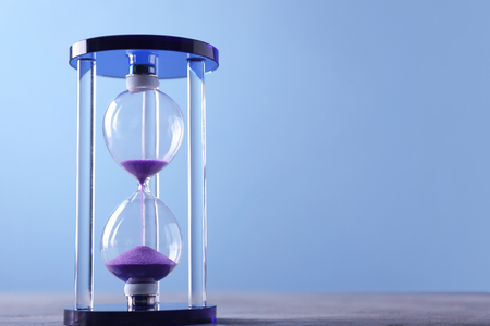 Stylish hourglass on color background. Time management conceptの写真素材