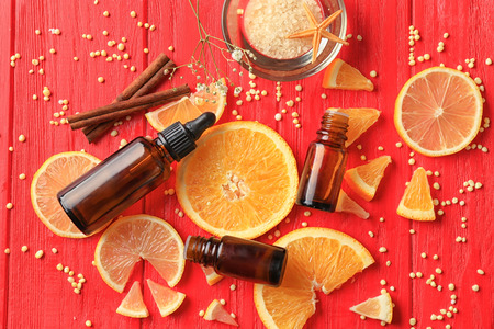 Composition with citrus essential oils on wooden background, top viewの写真素材