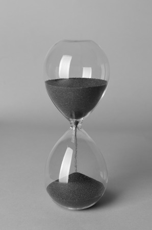 Hourglass on grey background. Time management concept