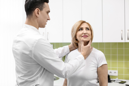 Orthopedist examining patient in hospital