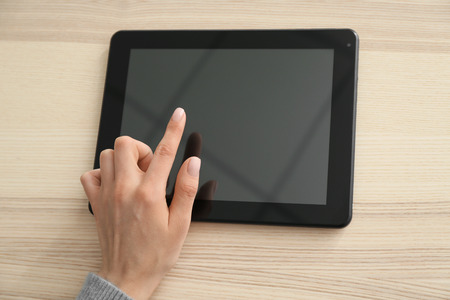 Young woman using tablet computer for online food delivery