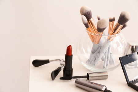 Set of makeup brushes with decorative cosmetics on tableの写真素材