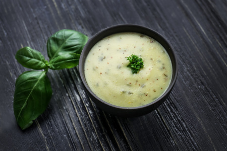 Tasty sauce in bowl on wooden tableの写真素材
