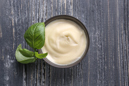 Tasty sauce in bowl on wooden tableの写真素材