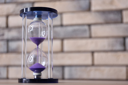 Crystal hourglass on table. Time management conceptの写真素材