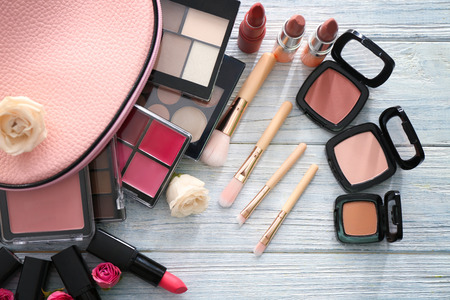 Set of decorative cosmetics with brushes on wooden tableの写真素材