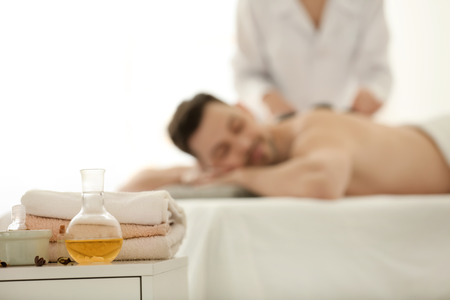 Spa treatments with blurred man on background indoorsの写真素材