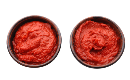 Bowls with delicious tomato sauce on white backgroundの写真素材