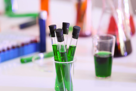 Test tubes with color samples on table in modern laboratory