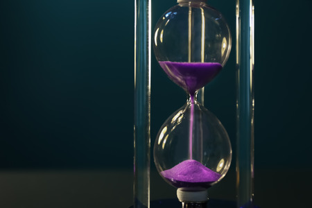 Crystal hourglass on color background. Time management conceptの写真素材