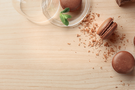 Flat lay composition with delicious chocolate macarons on light backgroundの写真素材