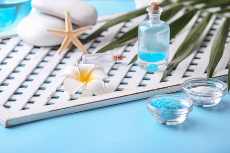 Beautiful spa composition with sea salt and flower on tableの写真素材