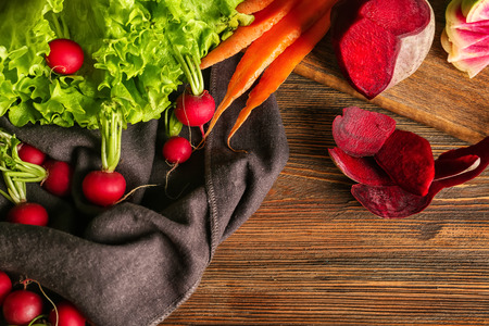 Flat lay composition with ripe fresh vegetables on wooden table