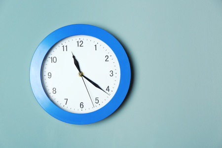 Modern clock on color wall. Time management conceptの写真素材