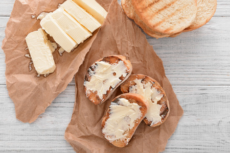 Tasty toasted bread with butter on tableの写真素材