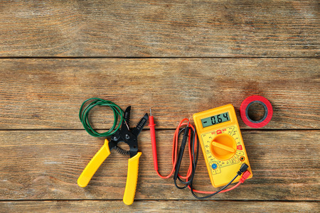 Flat lay composition with electrical tools on wooden background